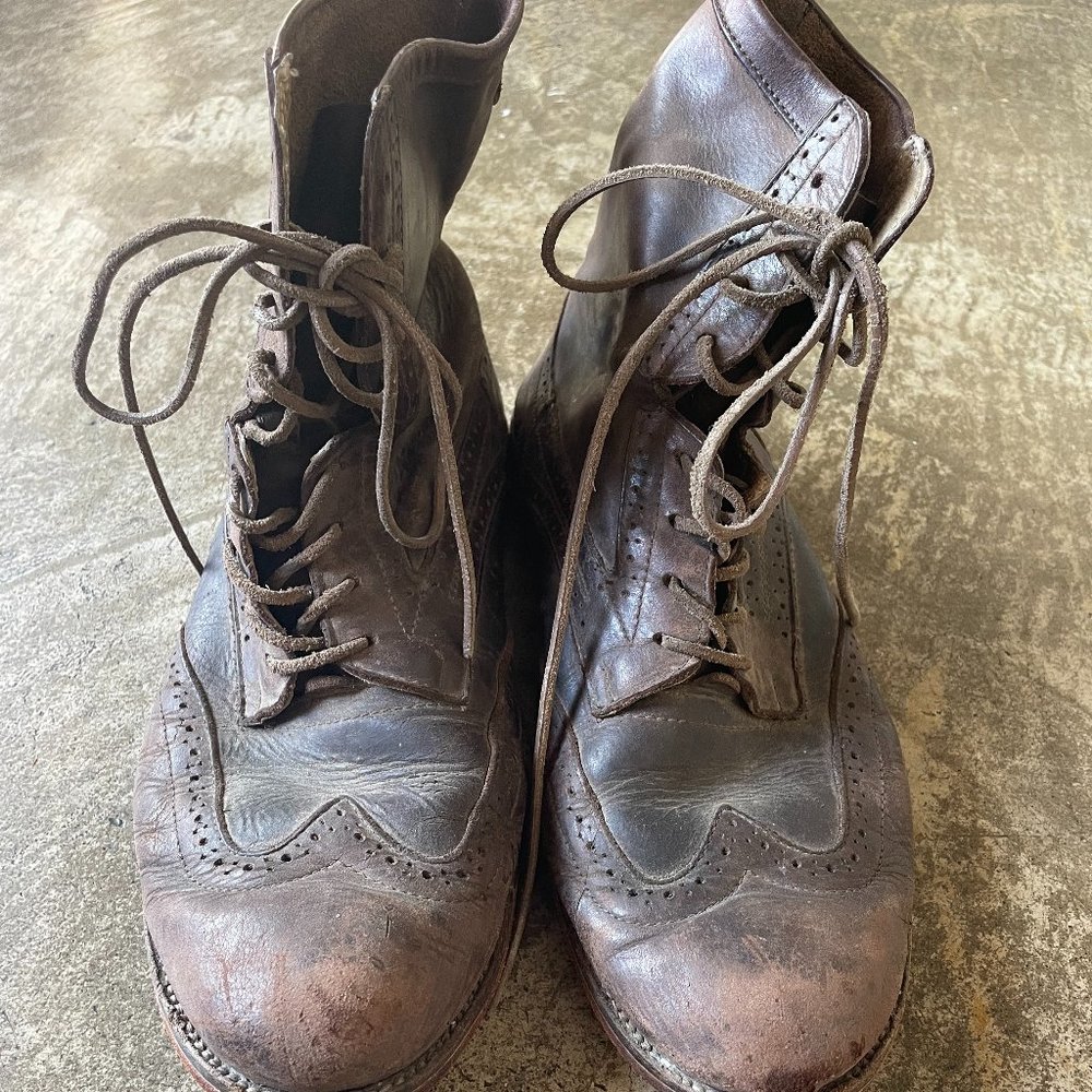 Wing tipped brown leather boots